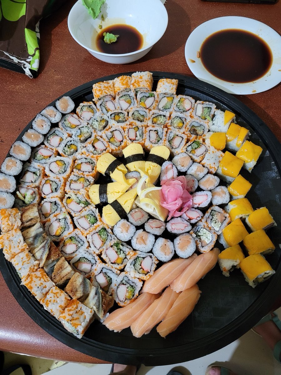 A round platter of assorted sushi rolls